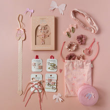Load image into Gallery viewer, A coordinated hair accessory gift set arranged on a soft pink background, including a long decorative hair tie, boxed hair clips, scrunchies, elastic bands, a fabric pouch, and a round hair tie case. The items are mostly blush pink with small white and metallic accents.
