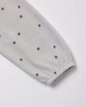 Load image into Gallery viewer, A close-up of a light gray ribbed fabric sleeve or cuff with a scattered dark gray star pattern, shown on a plain light background.
