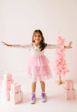 Load image into Gallery viewer, Child standing with arms outstretched in a Sugar Plum tutu dress and purple high-top sneakers.
