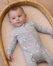Load image into Gallery viewer, Baby lying in a woven basket wearing a gray snowman-print footie, showing the front zipper and long sleeves.

