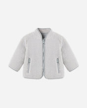 Load image into Gallery viewer, Fog gray shearling zip jacket with a stand collar, long sleeves, and two zippered front pockets on a white background.
