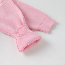 Load image into Gallery viewer, Close-up of a light pink knit garment, showing the ribbed cuffs and textured fabric on a plain white background.

