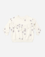 Load image into Gallery viewer, An off-white long-sleeve children's sweatshirt featuring a ruffled chest detail and an all-over daisy pattern with small red centers, shown flat on a light gray background.
