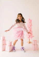 Load image into Gallery viewer, Child twirling in a Sugar Plum dress, with the tiered pink tulle skirt flaring outward.

