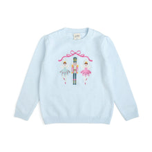 Load image into Gallery viewer, A light blue long-sleeve knit sweater with a colorful ballet-themed graphic on the chest featuring ballerina and nutcracker figures under a pink bow, shown on a plain white background.

