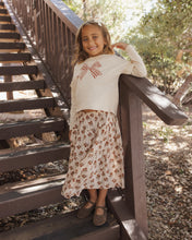 Load image into Gallery viewer, Ruffle Long Sleeve Tee in Bow, cream on a girl, front view on stairs
