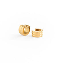 Load image into Gallery viewer, Pair of gold-tone chunky hoop earrings with a triple-band design, shown at different angles on a white background.

