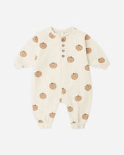 Load image into Gallery viewer, An off-white long-sleeve baby romper with a repeating pumpkin print, featuring a snap-button closure at the neckline, shown against a light gray background.
