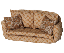 Load image into Gallery viewer, Angled view of Maileg ocher mouse sofa bed showing rounded armrests, patterned cushions, and floral throw pillows.
