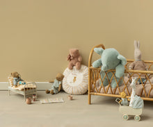 Load image into Gallery viewer, Soft mint plush elephant leaning on a wooden chair beside a cushioned window seat and miniature toys.
