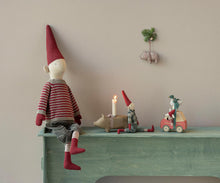 Load image into Gallery viewer, Maileg Christmas display on a green mantel with pixy dolls, a pig-shaped candleholder, and Little Sister mouse beside her red car box.
