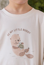 Load image into Gallery viewer, A close-up of a child wearing a cream-colored crewneck sweatshirt with a cute cartoon otter graphic holding a turtle and the text 'BE MY LITTLE BUDDY'.
