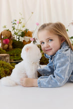 Load image into Gallery viewer, Side view of Moon the Kitty plush beside a smiling child in a blue floral denim jacket.
