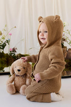Load image into Gallery viewer, Child kneeling beside Honey the Puppy plush and gently patting its head.
