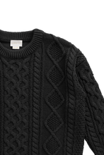Load image into Gallery viewer, Close-up of a black cable-knit sweater with textured diamond and vertical stripe patterns, featuring a ribbed crew neck and a visible neck label that reads 'LAVEETS'.
