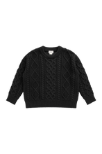Load image into Gallery viewer, A black cable-knit crewneck sweater with long sleeves, laid flat against a solid white background.
