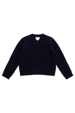 Load image into Gallery viewer, A dark navy blue cable-knit cropped cardigan sweater with a button-up front, laid flat against a solid white background.
