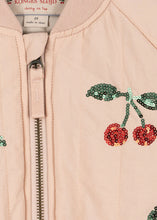 Load image into Gallery viewer, Close-up of a pink jacket with cherry designs and a zipper, featuring Konges Slojd brand.
