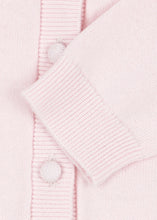 Load image into Gallery viewer, Close-up of a light pink knit cardigan with a ribbed button placket and matching buttons.

