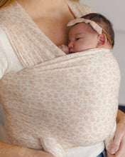 Load image into Gallery viewer, Woman holding a baby in a floral-patterned sling.
