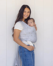 Load image into Gallery viewer, Woman holding a baby in a sling against a white background
