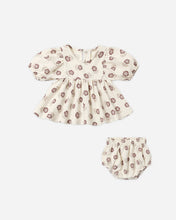 Load image into Gallery viewer, A baby girl's two-piece outfit set featuring a short-sleeve puff-sleeve top and matching bloomers, both in a cream-colored cotton fabric with a brown floral pattern, shown on a light gray background.
