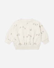 Load image into Gallery viewer, An off-white long-sleeve crewneck sweatshirt with a delicate all-over print of small deer and trees in muted brown and gray tones, displayed flat against a light gray background.
