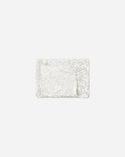 Load image into Gallery viewer, A folded white fabric item with a subtle silver floral pattern on the outer edges and a smooth white inner flap, centered on a light gray background.
