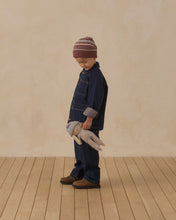 Load image into Gallery viewer, Child looking down at Ryder the Rabbit while carrying the doll at their side.
