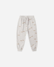 Load image into Gallery viewer, A pair of light gray jogger pants with an all-over print of small brown foxes, featuring an elastic waistband with a drawstring and ribbed cuffs, shown against a plain light gray background.
