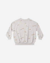 Load image into Gallery viewer, A light beige crewneck sweatshirt with a small all-over print of brown bows and tiny scattered dots, displayed flat against a light gray background.
