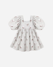 Load image into Gallery viewer, A baby girl's short-sleeve dress with puff sleeves, a square neckline, and an allover floral print on a light gray background, shown against a plain light gray studio background.
