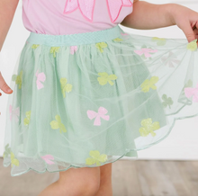 Load image into Gallery viewer, Green skirt with pink bow and light green four-leaf clover patterns worn by a person.

