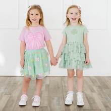 Load image into Gallery viewer, Two young girls holding hands, wearing outfits with pink and green colors.
