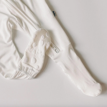 Load image into Gallery viewer, White baby pants with footies on a light gray background
