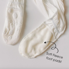 Load image into Gallery viewer, White footies with soft fleece foot pads on a light gray background
