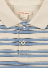 Load image into Gallery viewer, Close-up of a striped polo shirt with a visible brand label.
