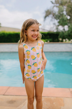Load image into Gallery viewer, Young girl in a pink swimsuit with lemon pattern standing by a pool.
