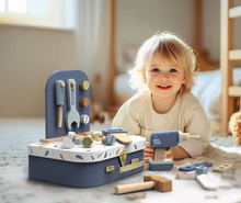 Load image into Gallery viewer, Child playing with a toy tool set on a carpeted floor.
