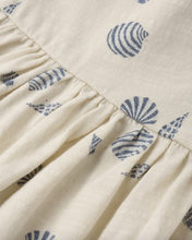 Load image into Gallery viewer, Close-up of a fabric with blue shell patterns on a beige background
