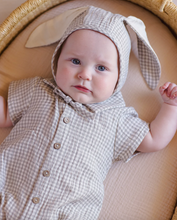 Load image into Gallery viewer, Baby wearing a checkered outfit with bunny ears on a beige background

