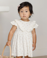 Load image into Gallery viewer, Young child wearing a white dress with ruffled sleeves against a plain background
