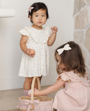 Load image into Gallery viewer, Two young girls in dresses standing indoors with a stone wall background.
