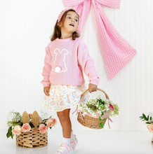 Load image into Gallery viewer, Child wearing a pink sweater with a bunny design, holding a basket of flowers, standing in front of a pink checkered curtain.
