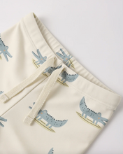 Load image into Gallery viewer, Beige fabric with blue crocodile pattern on a white background
