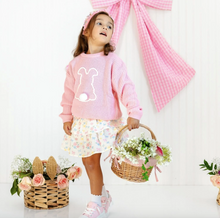 Load image into Gallery viewer, Young girl in a pink outfit with floral elements and baskets of flowers on a white background
