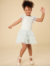 Load image into Gallery viewer, Young girl wearing a light green dress with ruffled sleeves and bottom on a beige background
