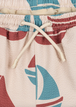 Load image into Gallery viewer, Close-up of colorful shorts with sailboat design and drawstring.
