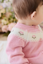 Load image into Gallery viewer, Close-up of a baby wearing a pink knitted sweater with floral patterns.
