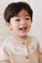 Load image into Gallery viewer, Child wearing a beige sweater with a pattern, smiling against a light background
